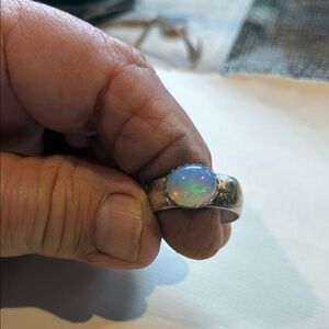 Beautiful iridescent opal set in 925 generous band 7 3/4